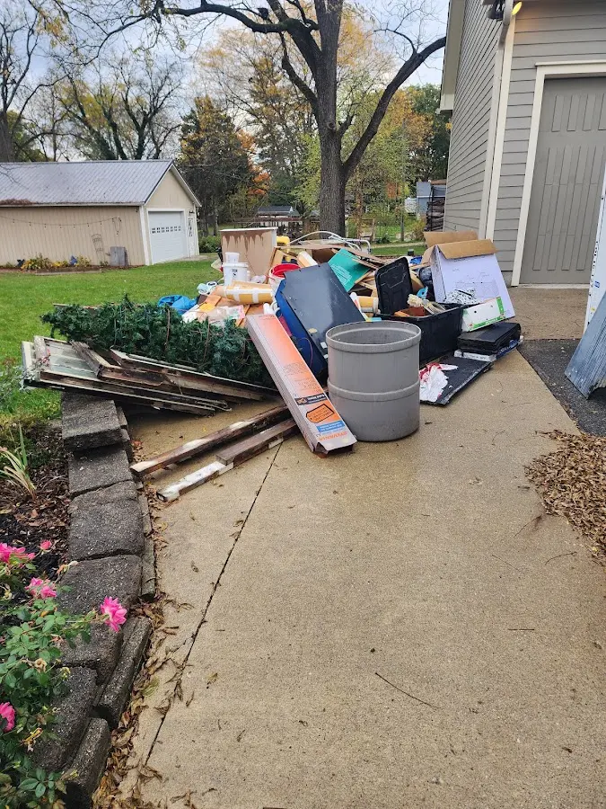 Dumpster being loaded with debris for Estate Cleanout Dumpster Rental in Ogallala
